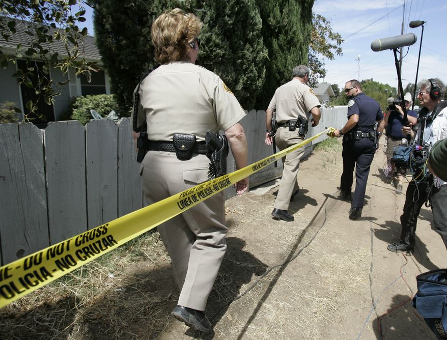 **FILE** Police tape off the area around a home where authorities say kidnapped victim Jaycee Lee Dugard lived in Antioch, Calif., on Aug. 28, 2009. (Associated Press)