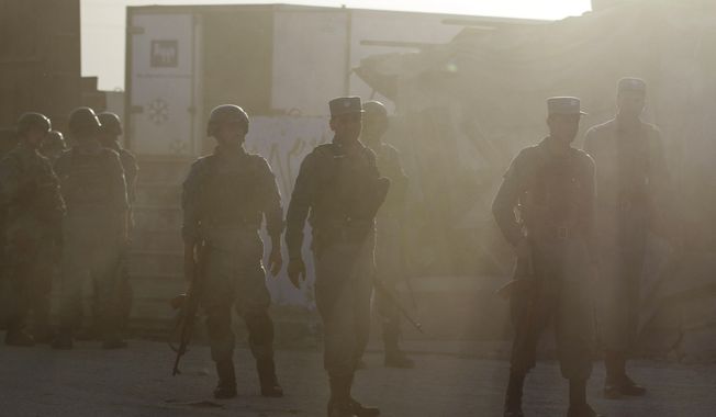 Afghan policemen guard after Taliban fighters attacked near Kabul&#x27;s airport, Afghanistan, Monday, June 10, 2013. (AP Photo/Ahmad Jamshid)

