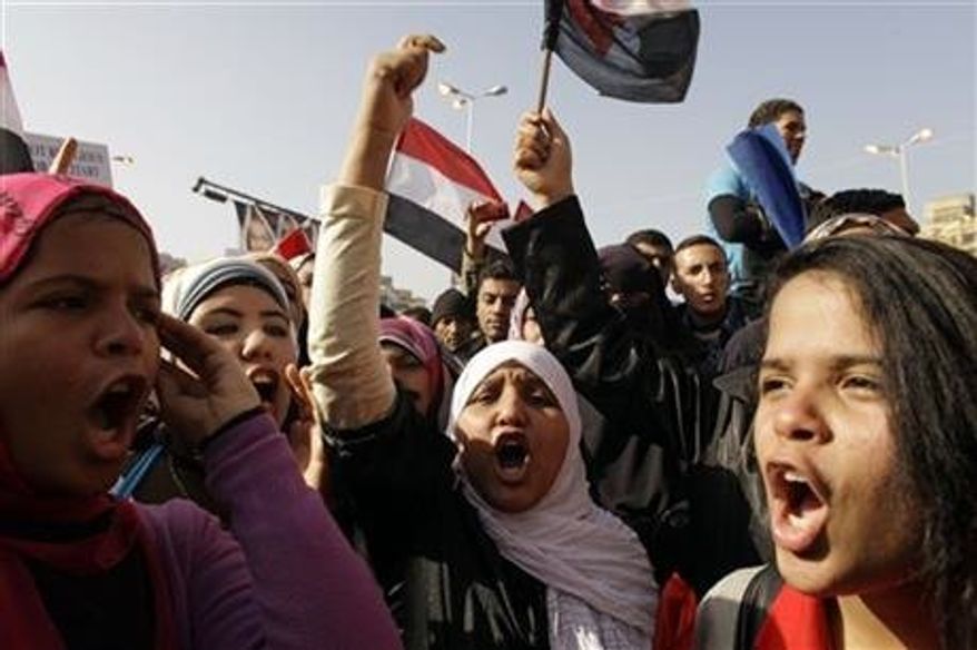** FILE ** Egyptian girls chant slogans in Tahrir Square during a rally to mark the one year anniversary of the uprising that ousted President Hosni Mubarak in Cairo, Egypt, Jan 25, 2012. Egyptian women are growing increasingly angry as they deal with an epidemic of sexual assault. (Associated Press)