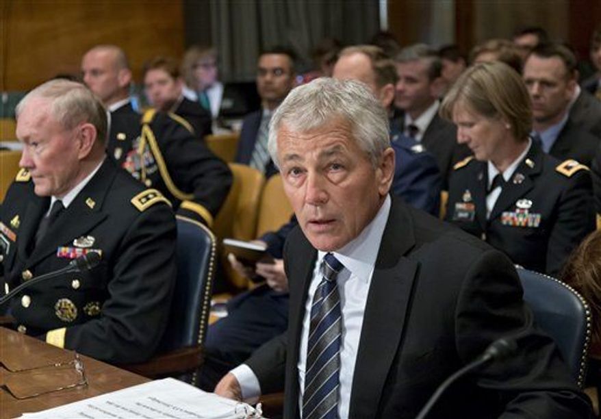 Defense Secretary Chuck Hagel, center, flanked by Joint Chiefs Chairman Gen. Martin Dempsey, left, and Pentagon Comptroller Robert Hale, listens on Capitol Hill in Washington, Tuesday, June 11, 2013, during the Senate Defense subcommittee hearing on department leadership. (Associated Press)