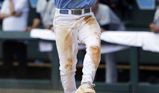 North Carolina&#39;s Landon Lassiter (12) reacts as he scores in the sixth inning of an NCAA college baseball tournament super regional game against South Carolina in Chapel Hill, N.C., Tuesday, June 11, 2013. North Carolina won 5-4 to advance to the College World Series. (AP Photo/Gerry Broome)