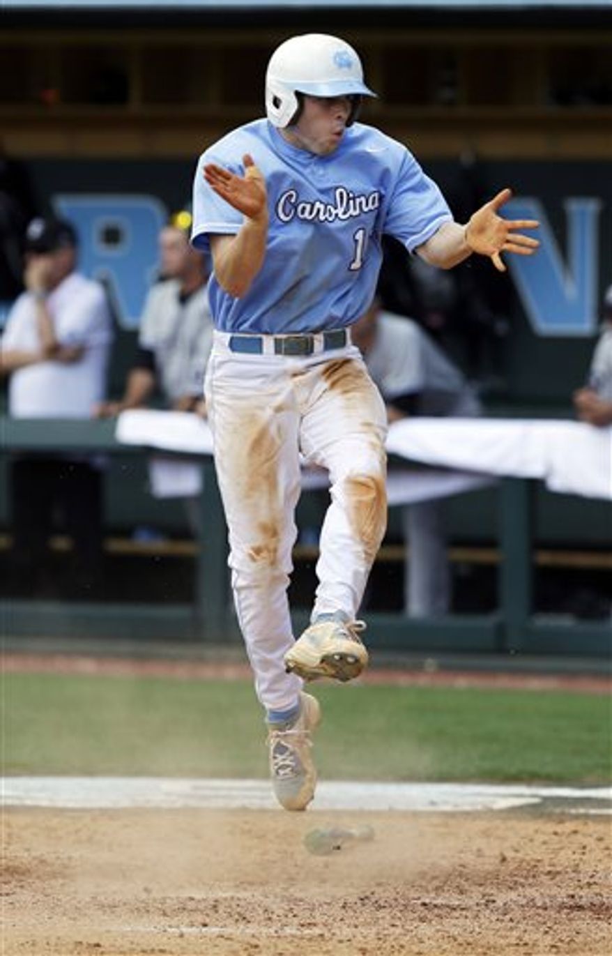 North Carolina's Landon Lassiter (12) reacts as he scores in the sixth inning of an NCAA college baseball tournament super regional game against South Carolina in Chapel Hill, N.C., Tuesday, June 11, 2013. North Carolina won 5-4 to advance to the College World Series. (AP Photo/Gerry Broome)