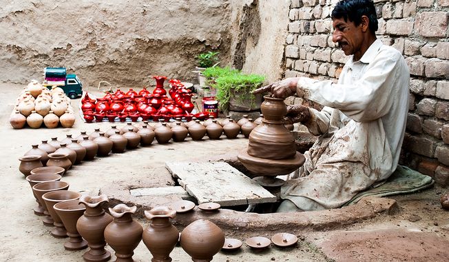 Baseer runs a pottery workshop in Jamrud, Khyber Agency, in FATA. He works on a machine pedaled by his feet. Some of his pots are used for drinking water; others are for kids to collect coins called khazana, treasure, in the local language. To get the money out, the children have to break to pot. Photo / Muhammad Khalid Afridi 