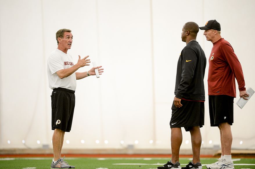 Left to right: Washington Redskins head coach Mike Shanahan talks with and defensive backs coach Raheem Morris and defensive coordinator Jim Haslett at mini camp at Redskins Park, Ashburn, Md., Tuesday, June 11, 2013. (Andrew Harnik/The Washington Times)