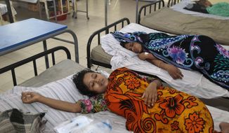 Bangladeshi garment workers who fell ill during their shifts at a sweater factory lie on beds at a hospital on the outskirts of Dhaka, Bangladesh, on June 6, 2013. About 450 garment workers fell ill at the Starlight Sweater Factory near Bangladesh&#39;s capital, due to possible water contamination. A building collapse near Dhaka in April killed 1,129 workers, injured others and highlighted the hazardous working conditions in thousands of garment factories in Bangladesh. (Associated Press)