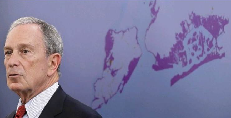 New York City Mayor Michael Bloomberg speaks while a map of the projected 2050s 100-year flood plain of New York City is displayed in New York, Tuesday, June 11, 2013. The projections paint an unsettling picture of New York's future: a city where by the 2050s, 800,000 people could be living in a flood zone that would cover a quarter of the land, and there could be as many 90-degree days as is now normal for Birmingham, Ala. (AP Photo/Seth Wenig)