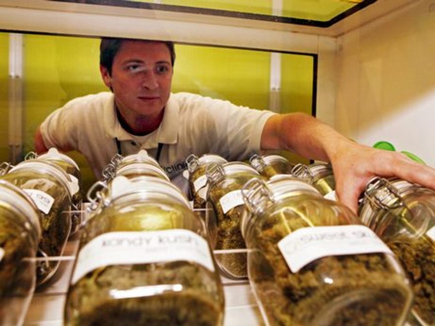 A man reaches for a jar of medical marijuana at a Denver clinic. (Associated Press)