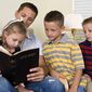 A father reads from the Bible with his children. (Credit: Deseret News)