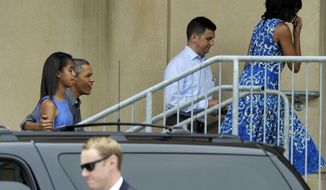 President Obama, with his arm around daughter Malia, and first lady Michelle Obama (right) arrive at the Music Center at Strathmore in North Bethesda, Md., on Sunday, June 16, 2013, to attend daughter Sasha&#39;s dance recital. (AP Photo/Susan Walsh)

