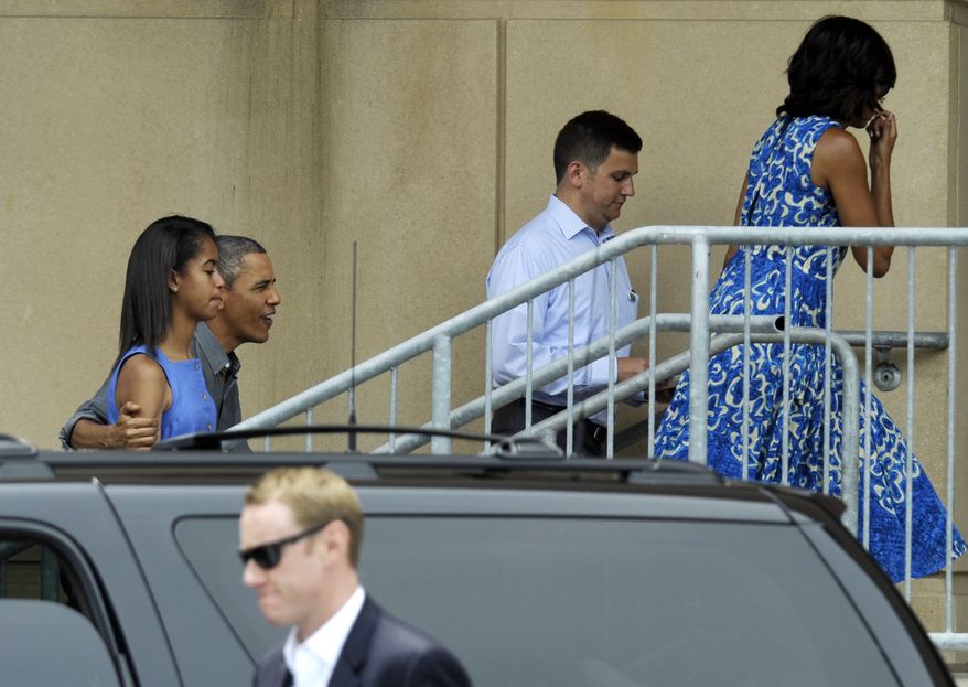 President Obama, with his arm around daughter Malia, and first lady Michelle Obama (right) arrive at the Music Center at Strathmore in North Bethesda, Md., on Sunday, June 16, 2013, to attend daughter Sasha's dance recital. (AP Photo/Susan Walsh)