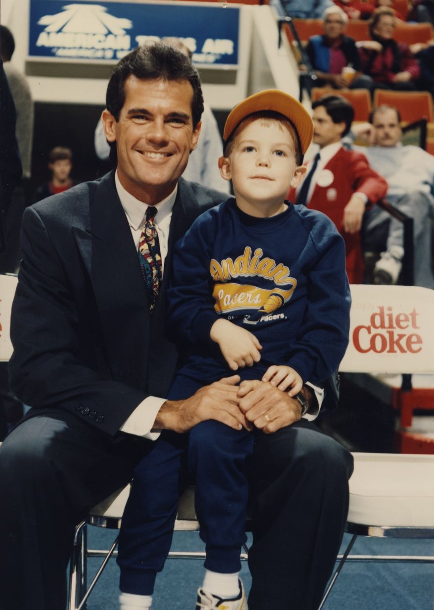 Five-year-old Drew Storen sits on the lap of his father Mark, a sportscaster. Baseball and other sports were a major part of their lives as Drew was growing up and on his way to becoming a relief pitcher for the Nationals.