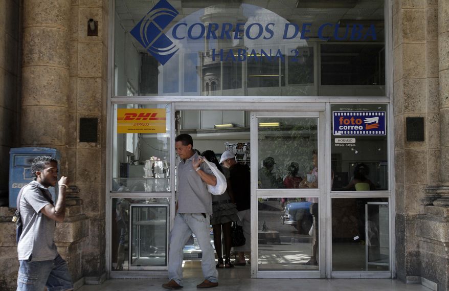 **FILE** A man leaves a postal office in Havana on Nov. 25, 2010. (Associated Press)