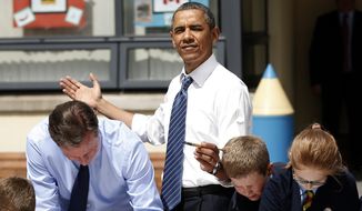 ** FILE ** President Obama (center) reacts as the sun comes out as he and British Prime Minister David Cameron (left) help students as they work on a school project about the G-8 summit during a visit to the Enniskillen Integrated Primary School in Enniskillen, Northern Ireland, on June 17, 2013. The visit took place before leaders from the G-8 nations were to gather to discuss the ongoing conflict in Syria and free-trade issues. (Associated Press)