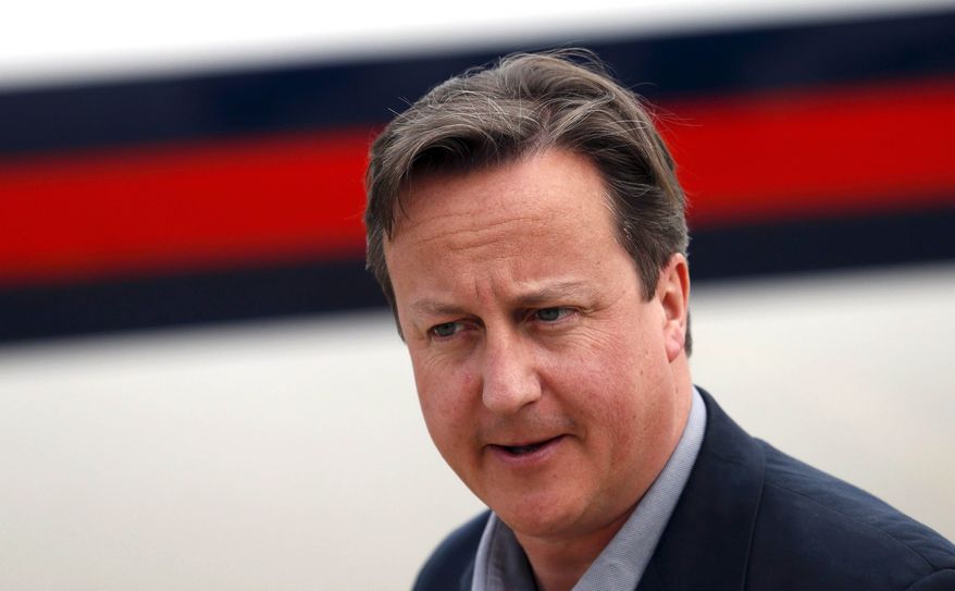 Britain's Prime Minister David Cameron arrives to attend the Enniskillen G-8 summit at the 38th Irish Brigade Flying Station Aldergrove near Belfast, Northern Ireland on Sunday, June 16, 2013. (AP Photo/Suzanne Plunkett, Pool)