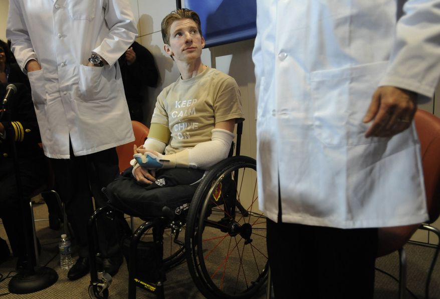 ** FILE ** In this Tuesday, Jan. 29. 2013, photo, retired Infantryman Brendan M. Marrocco participates in a news conference at Johns Hopkins hospital in Baltimore. Marrocco received a transplant of two arms from a deceased donor after losing all four limbs in a 2009 roadside bomb attack in Iraq. A Boston hospital is starting the world's first pediatric hand transplant program, a profound sign of the increased acceptance of doing face, hand and other transplants to improve quality of life rather than to save a life as donated hearts, livers and other organs have in the past. (AP Photo/Gail Burton, File)