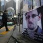 **FILE** A banner supporting Edward Snowden, a former CIA employee who leaked top-secret documents about sweeping U.S. surveillance programs, is displayed at Central, Hong Kong&#39;s business district, on June 17, 2013.  (Associated Press)