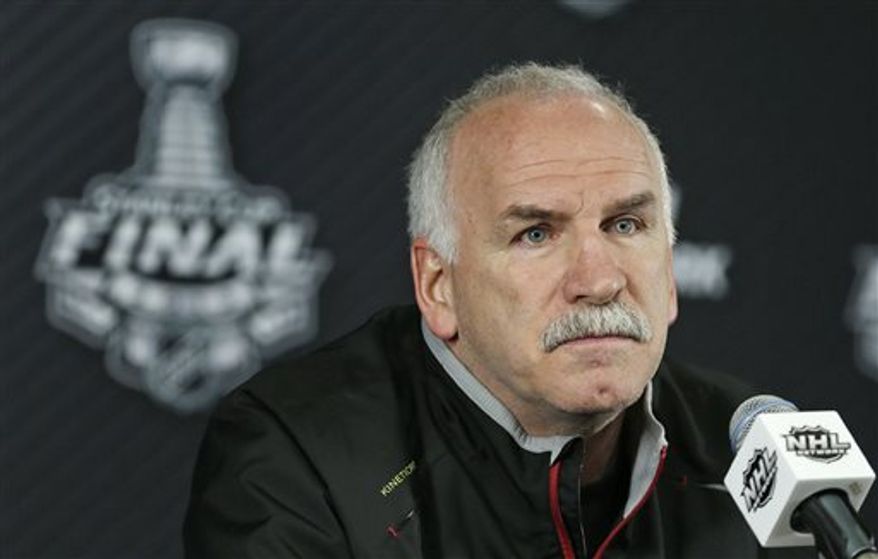 Chicago Blackhawks head coach Joel Quenneville listens to a reporter's question during a press conference in Boston, Tuesday, June 18, 2013. The Blackhawks trail the Boston Bruins 2-1 in the best-of-seven series in the Stanley Cup Finals. Game 4 is scheduled for Wednesday in Boston. (AP Photo/Charles Krupa)