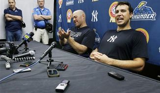 **FILE** New York Yankees general manager Brian Cashman, left, and third baseman Kevin Youkilis, center, listen as first baseman Mark Teixeira, right, answers a question during a news conference in Trenton, N.J., Wednesday, May 29, 2013, after Youkilis and Teixeira played a rehab game with the Trenton Thunder. Teixeira has been sidelined with a right wrist injury since March, and Youkilis has missed nearly 30 games with a back injury. (AP Photo/Mel Evans)