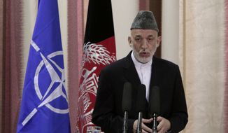 Afghan President Hamid Karzai speaks during a ceremony at military academy on the outskirts of Kabul, Afghanistan, on Tuesday, June 18, 2013. Mr. Karzai announced at the event that his country&#39;s armed forces are taking over the lead for security nationwide from the U.S.-led NATO coalition. (AP Photo/Rahmat Gul)