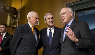 Senate Judiciary Committee Chairman Patrick Leahy (right), Vermont Democrat, and committee member Sen. Orrin Hatch (left), Utah Republican, greet FBI Director Robert Mueller on Capitol Hill on June 19, 2013, prior to the start of the committee&#39;s hearing on national security matters. Mueller is nearing the end of his 12 years as head of the law enforcement agency. (Associated Press)