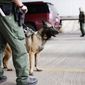 U.S. Customs and Border Patrol agents and K-9 security dogs keep watch at a checkpoint station, on Feb. 22, 2013, in Falfurrias, Texas. (Associated Press) **FILE**