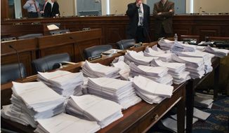 **FILE** Stacks of paperwork await members of the House Agriculture Committee on Capitol Hill in Washington on May 15, 2013, as it meets to consider proposals to the 2013 Farm Bill. (Associated Press)