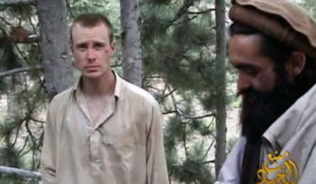 ** FILE ** This file image provided by IntelCenter on Wednesday Dec. 8, 2010, shows a frame grab from a video released by the Taliban containing footage of a man believed to be a U.S. soldier, Sgt. Bowe Bergdahl, left. (AP Photo/IntelCenter, File) 