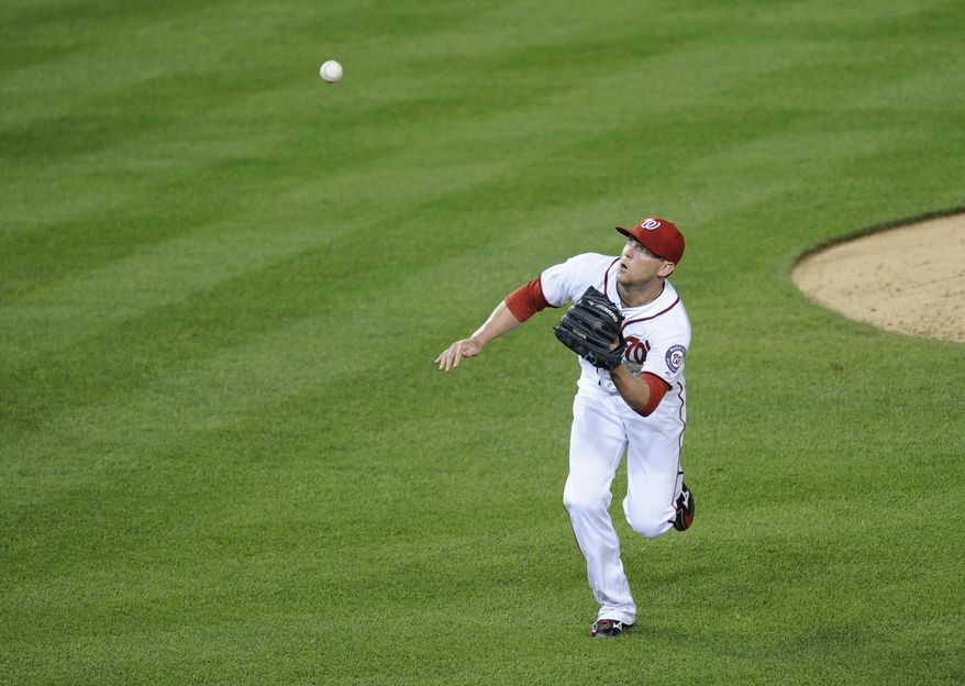 Drew Storen fielded a popped up bunt in the eighth inning on Friday night. (Associated Press photo)