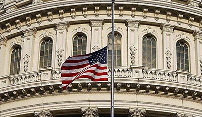** FILE ** An American flag flies at half-staff over the Capitol in Washington on Wednesday, Aug. 11, 2010, in honor of former Sen. Ted Stevens, who died in a plane crash in Alaska two days before. (AP Photo/Alex Brandon)