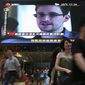 ** FILE ** A TV screen shows a news report of Edward Snowden, a former National Security Agency contractor who leaked top-secret documents about sweeping U.S. surveillance programs, at a shopping mall in Hong Kong Sunday, June 23, 2013. (AP Photo/Vincent Yu)