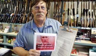 **FILE** Paradise Firearms owner Paul Paradis holds a flyer depicting Colorado&#39;s State Senate President, Democrat John Morse, together with a petition to recall him at his gun shop in Colorado Springs, Colo., on May 24, 2013. Paradis and other gun-rights activists are seeking the ouster of Morse for his support of new laws that restrict ammunition magazines and expand background checks to include private gun sales. (Associated Press)
