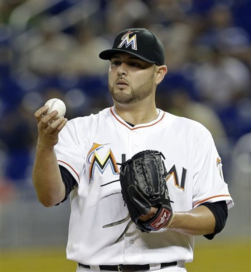 **FILE** Miami Marlins' Ricky Nolasco checks out the ball during a baseball game Monday, June 10, 2013 in Miami. (AP Photo/Alan Diaz)