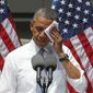 President Obama wipes his face as he speaks about climate change at Georgetown University in Washington on June 25, 2013. (Associated Press) **FILE**