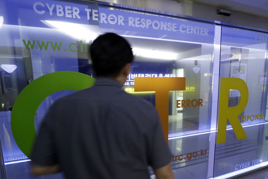 A man walks by a gate at Cyber Terror Response Center of National Police Agency in Seoul on Tuesday, June 25, 2013. South Korea said multiple government and private sector websites were hacked on Tuesday's anniversary of the start of the Korean War, and Seoul issued a cyberattack alert warning officials and citizens to take security measures. (Associated Press)