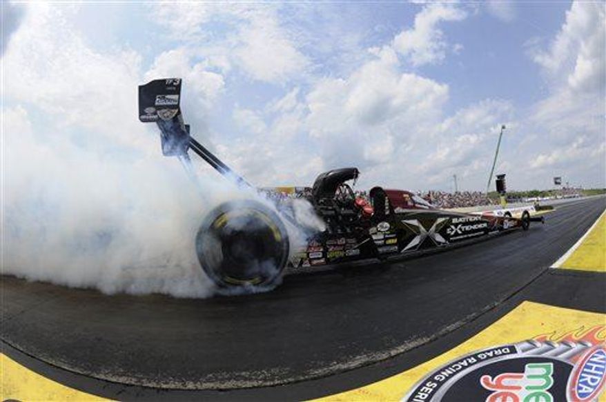 ** FILE ** Spencer Massey performs a burnout in his Schumacher Electric dragster en route to winning the NHRA New England Nationals auto race at New England Dragway, Sunday, June 23, 2013, in Epping, N.H. (Associated Press)