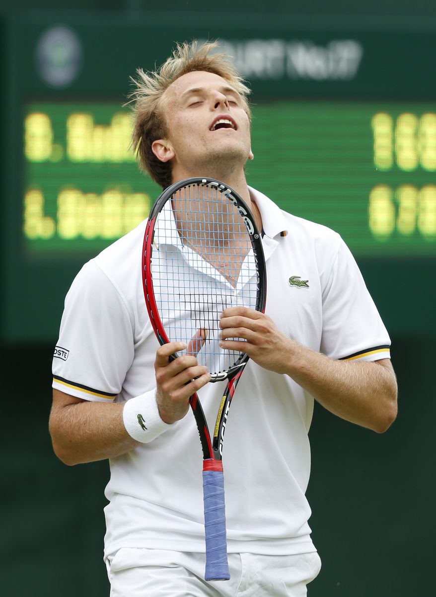 Denis Kudla of the United States reacts as he plays Ivan Dodig of Croatia in their Men's second round singles match at the All England Lawn Tennis Championships in Wimbledon, London, Thursday, June 27, 2013. (AP Photo/Sang Tan)