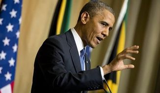 President Obama gestures during a news conference with South African President Jacob Zuma, not pictured, at the Union Building on Saturday, June 29, 2013, in Pretoria, South Africa. (AP Photo/Evan Vucci)