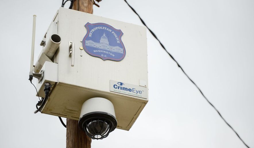 A Metropolitan Police Department camera sits high above home in the Berry Farms Neighborhood in Southeast. Police say they track criminal activity in areas to determine where the cameras are most useful. (Andrew Harnik/The Washington Times)