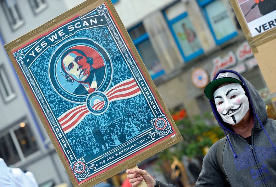 A demonstrator in Hanover, Germany, protests Internet and telephone surveillance by the U.S. National Security Agency on Saturday, June 29, 2013. (AP Photo/dpa, Peter Steffen)