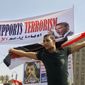 An Egyptian protesting President Mohammed Morsi waves a national flag in front of a banner criticizing Morsi and U.S. President Barack Obama in Tahrir Square, the focal point of Egyptian uprising, in Cairo on June 30, 2013. Thousands of opponents and supporters of the president began massing in city squares in competing rallies, gearing up for a day of massive nationwide protests that many fear could turn deadly as the opposition seeks to push out Mohammed Morsi. Arabic reads, &quot;Leave.&quot; (Associated Press)