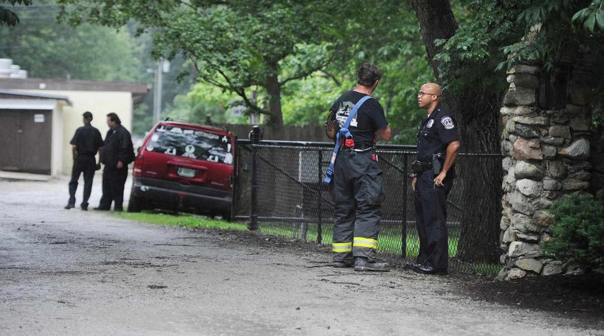A firefighter and a policeman confer at the scene of a lightning strike that caused injuries at 9300 Moore Road in Indianapolis Saturday afternoon, June 29, 2013. Indianapolis police say three children were injured at a summer camp on the north side of Indianapolis by the lightning strike. (AP Photo/The Indianapolis Star, Rob Goebel)