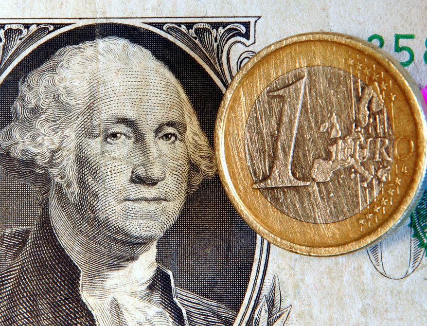 A $1 bill and a 1-euro coin (AP Photo/Michael Probst)