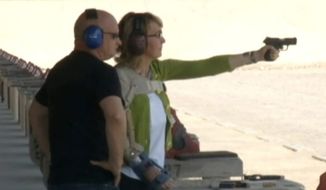 In this screen capture of a video from ABC News, former Arizona Rep. Gabrielle Giffords fires a pistol at a Las Vegas shooting range. It was the first time she has shot a gun since being shot in the head in 2011 during a gunman&#39;s rampage. With her is her husband, astronaut Mark Kelly.