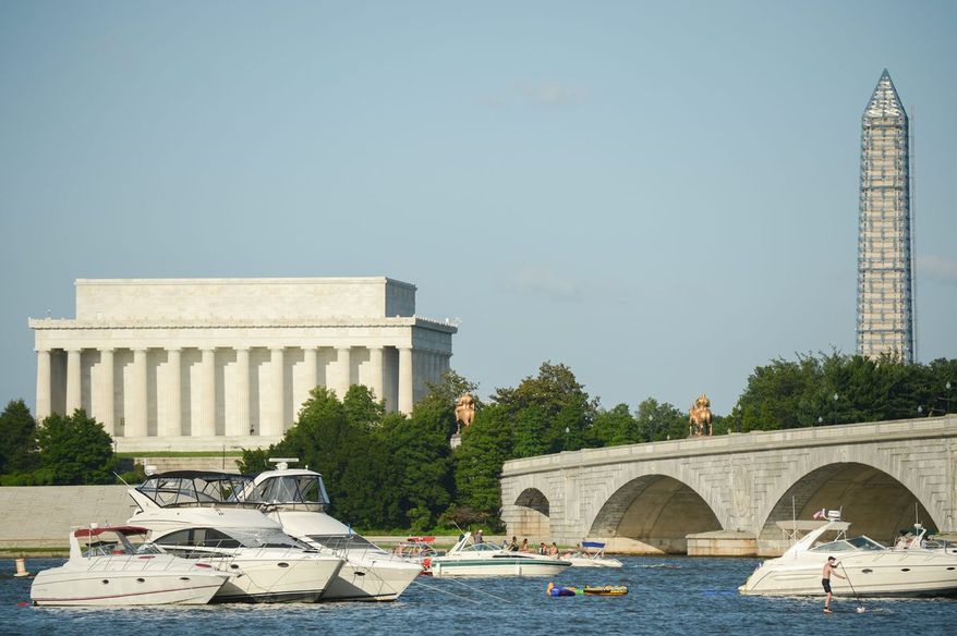 Boats crowd the Potomac River in anticipation of Independence Day fireworks on the Mall with the Lincoln Memorial in the background. (Andrew Harnik/The Washington Times)