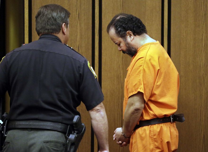 Ariel Castro is led back to jail after a hearing in Cuyahoga County Common Pleas Court in Cleveland, Wednesday, July 3, 2013. Castro is accused of holding three women captive for nearly a decade. (AP Photo/Mark Duncan)
