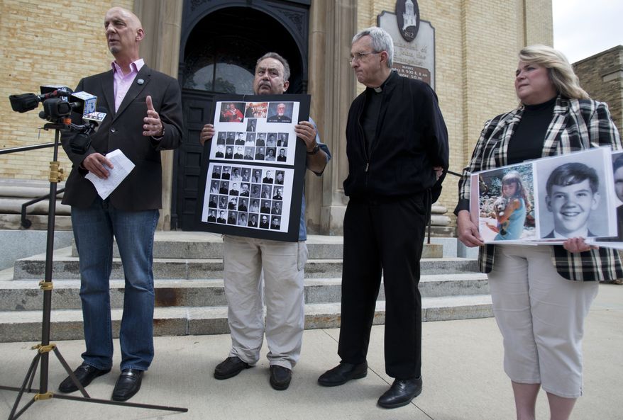From left: Peter Isely, Arthur Budzinski, Fr. James Connell and Monica Barrett talk about the importance of the release of priest abuse files by the Archdiocese of Milwaukee on the front stairs of St. John's Cathedral in Milwaukee on June 28, 2013. (Associated Press/Milwaukee Journal Sentinel)