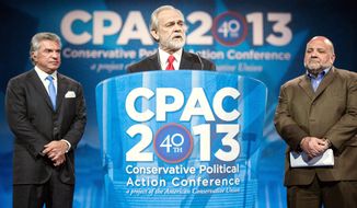 Washington Times President and CEO Larry Beasley announces the newspaper&#39;s straw poll results in March at the CPAC conference near Washington. He is joined by American Conservative Union Chairman Al Cardenas (left) and pollster Tony Fabrizio. (The Washington Times)