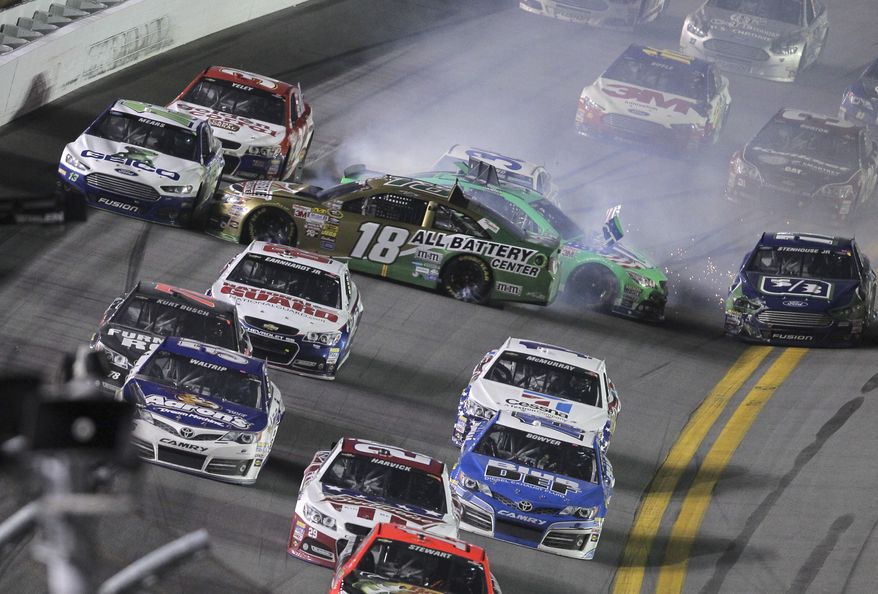 Kyle Busch (18) and Danica Patrick wreck on the last lap of the NASCAR Sprint Cup auto race at Daytona International Speedway, Saturday, July 6, 2013, in Daytona Beach, Fla. (AP Photo/David Graham)