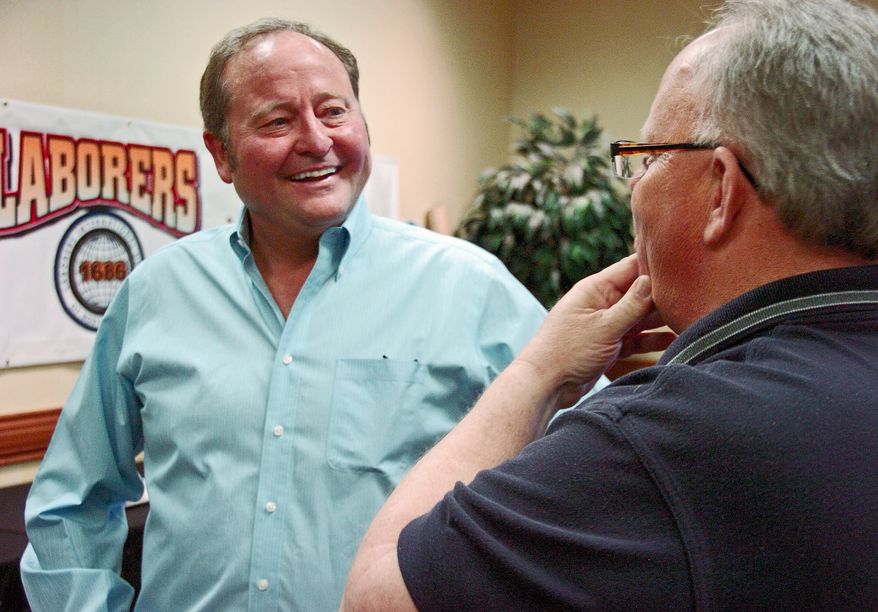 **FILE** Former Montana Gov. Brian Schweitzer (left) speaks with union representatives at the Montana AFL-CIO annual convention in Billings, Mont., on May 10, 2013. Schweitzer, who was endorsed by the AFL-CIO during his two gubernatorial campaigns, is considering a run for the U.S. Senate. (Associated Press)