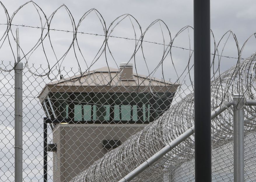 A guard tower looms over the fence surrounding the new California Correctional Health Care Facility in Stockton, Calif., on Tuesday, June 25, 2013. The $839 million facility will treat up to 1,720 patients in need of long-term care, freeing up staff and treatment space at the state's 33 adult prisons. (AP Photo/Rich Pedroncelli)